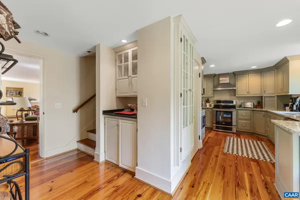 a kitchen with stainless steel appliances a refrigerator and wooden floor