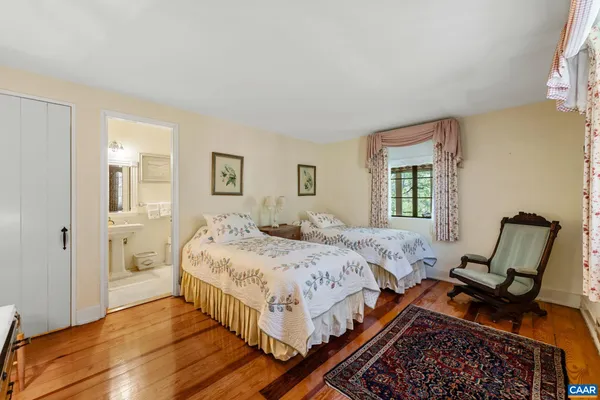 a bed room with a bed and chair
