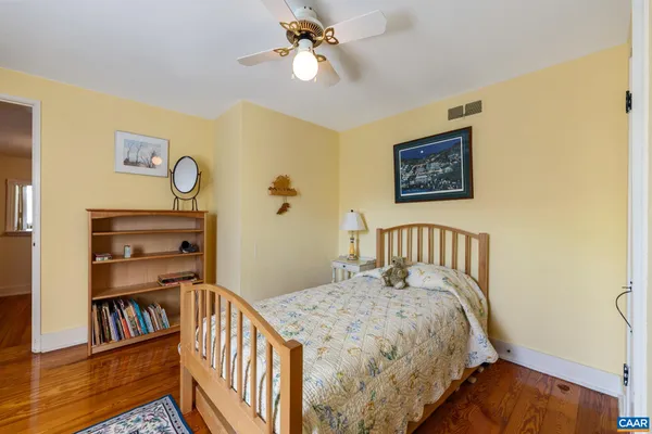a bedroom with a bed and a book shelf
