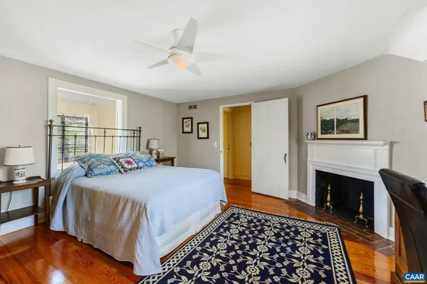 a bedroom with a bed and a fireplace