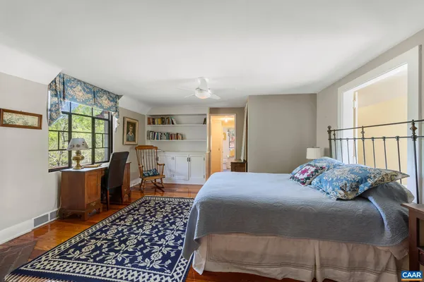 a bedroom with a large bed and a window