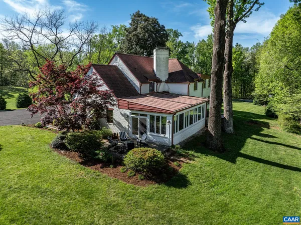 a view of a house with a yard and garden