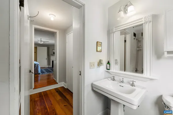 a bathroom with a sink a mirror and a shower
