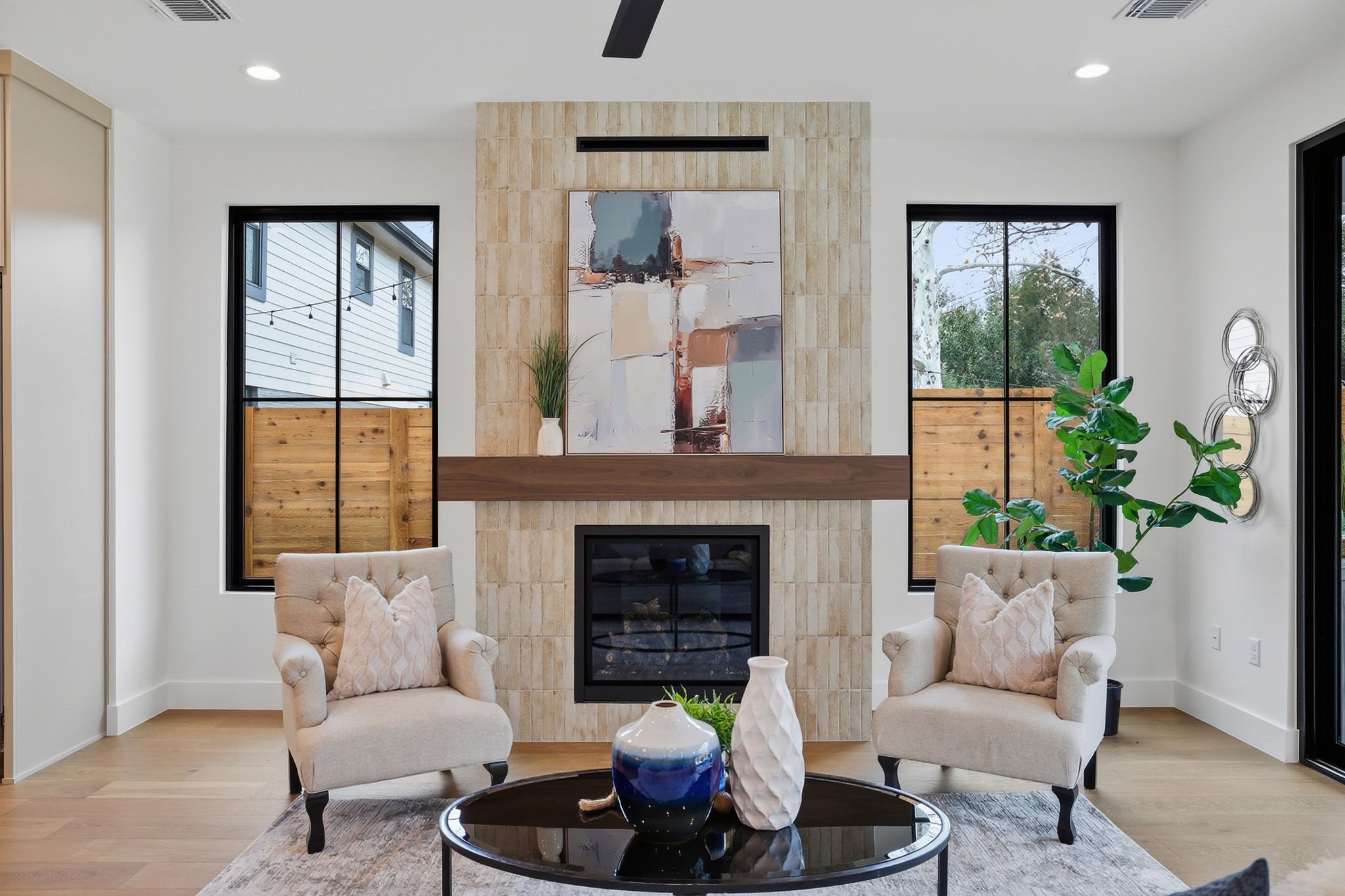 6611 Lexington Road Austin, TX 78757 - Photo 17 of 37 Modern fireplace featuring a stone-tile surround, dark wood mantel, and gas insert