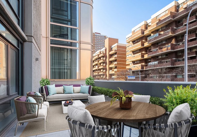 385 1st Avenue, Unit 2B Manhattan, NY 10010 - Photo 1 of 17 a roof deck with couch and potted plants