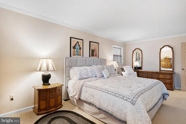 a bedroom with a bed and a potted plant