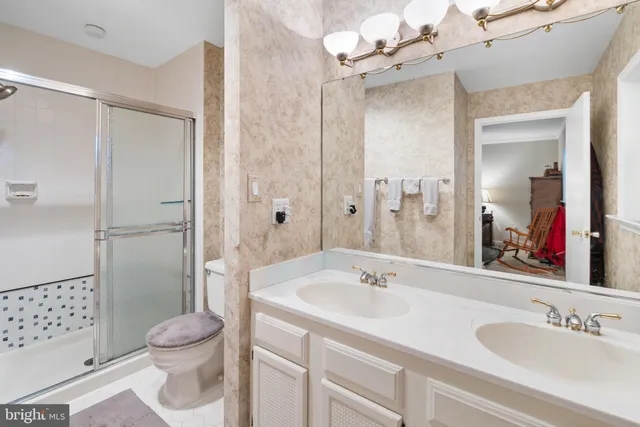 a bathroom with a sink toilet tub and shower