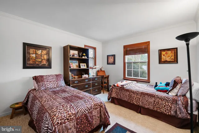 a bedroom with two beds and a window