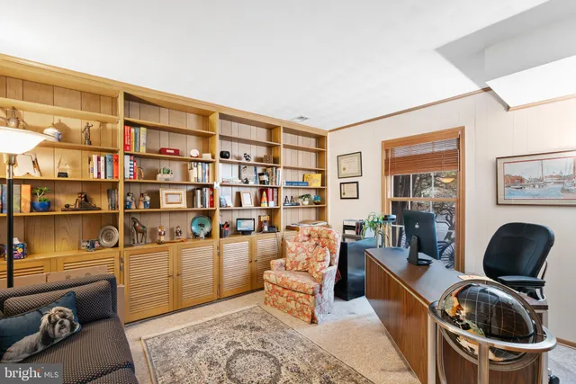 a living room with furniture and a book shelf