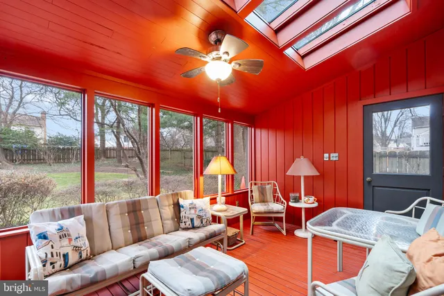 a living room with furniture a chandelier and a large window