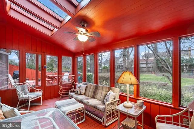 a living room with furniture a fireplace and a large window