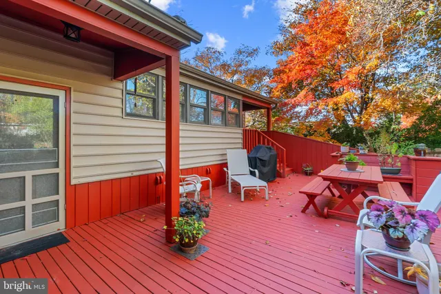a backyard of a house with seating space and wooden deck