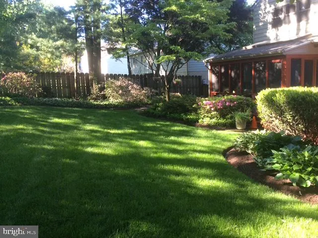 a view of a flower garden in front of house