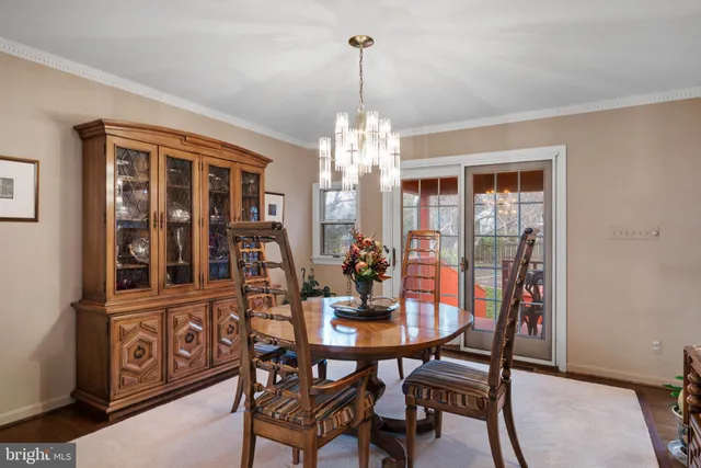 a view of a dining room with furniture and chandelier