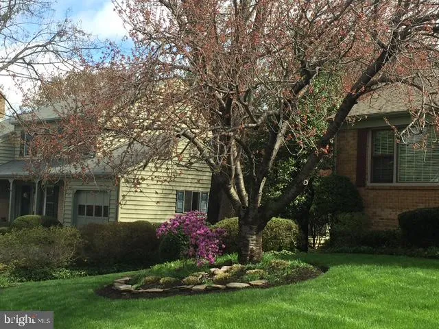 a front view of a house with a garden and yard
