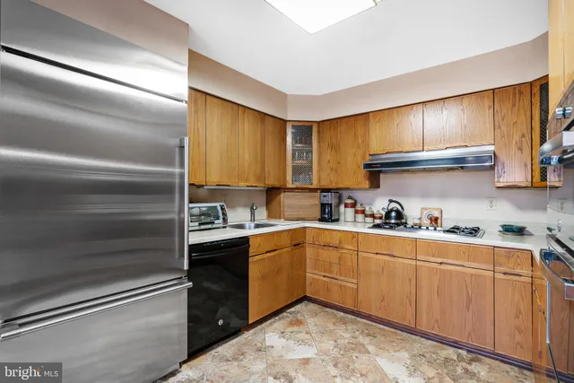 a kitchen with a sink cabinets and appliances