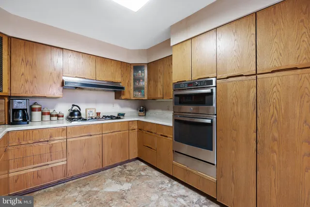 a kitchen with granite countertop stainless steel appliances and cabinets