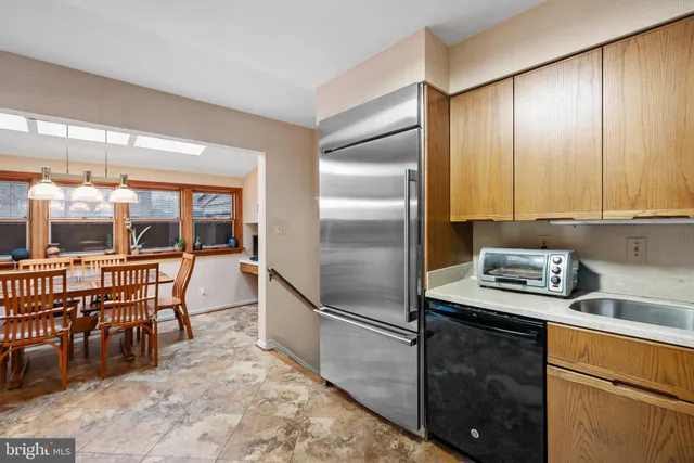 a kitchen with stainless steel appliances granite countertop a stove a refrigerator and island