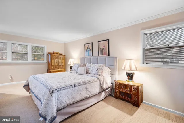 a bedroom with a bed wooden floor and window