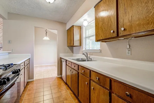 a kitchen with a sink stove and cabinets