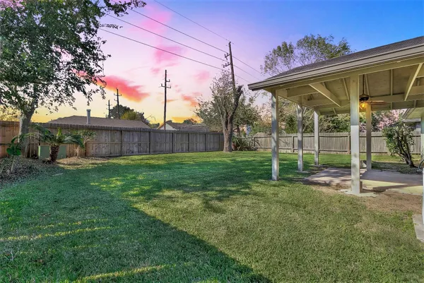 a view of a house with a backyard
