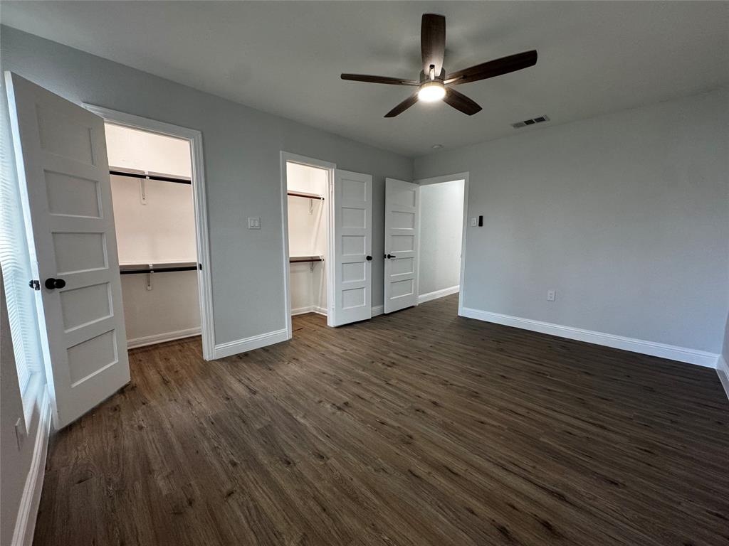 2909 Alexander Avenue Waco, TX 76708 - Photo 14 of 27 Unfurnished bedroom with dark wood-type flooring, a spacious closet, and a ceiling fan