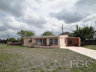 12 Apache Street Lehigh Acres, FL 33936 - Photo 1 of 1 a view of a house with a yard and fence