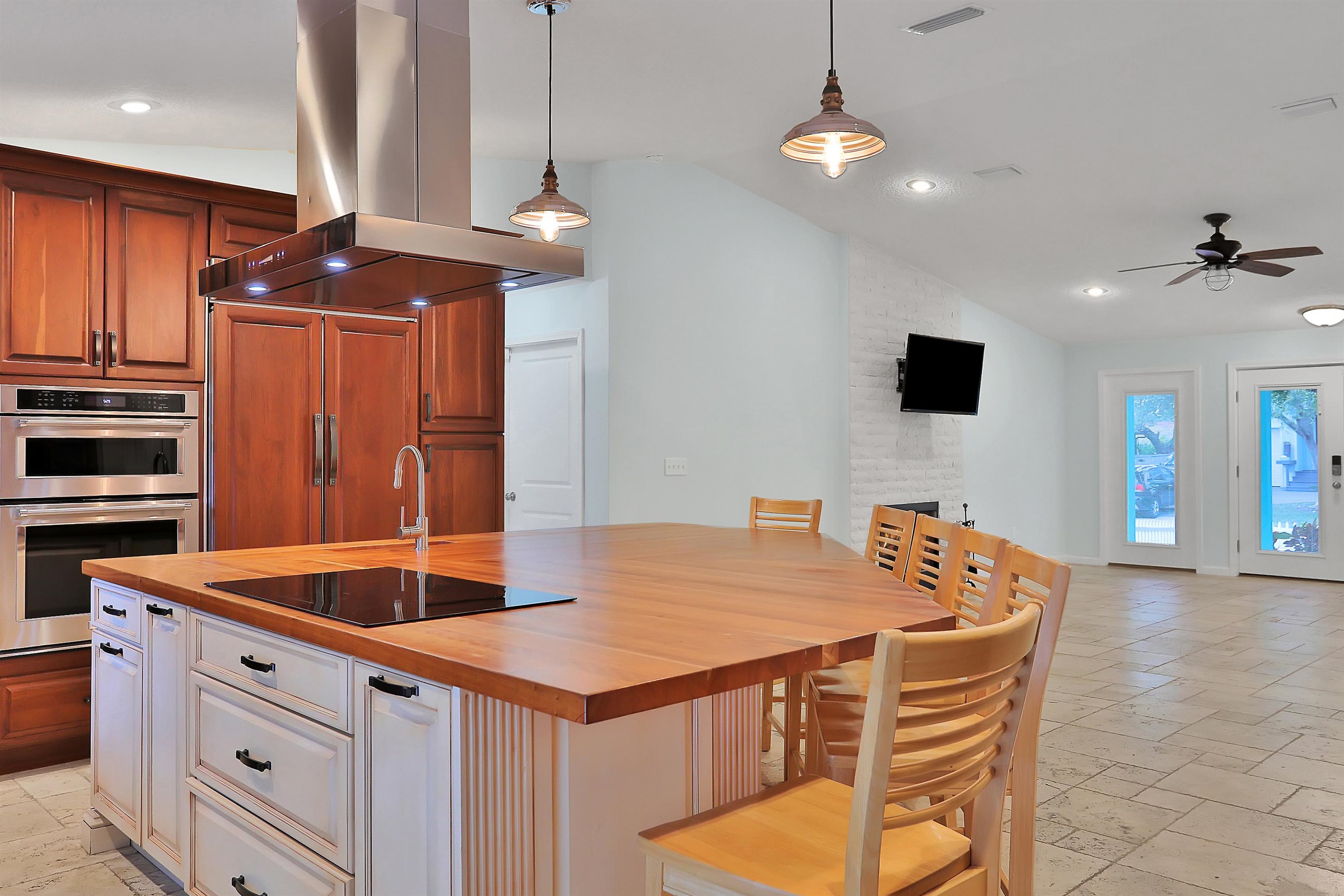 405 Boating Club Road St. Augustine, FL 32084 - Photo 12 of 35 a kitchen with stainless steel appliances kitchen island a table chairs in it and a kitchen island