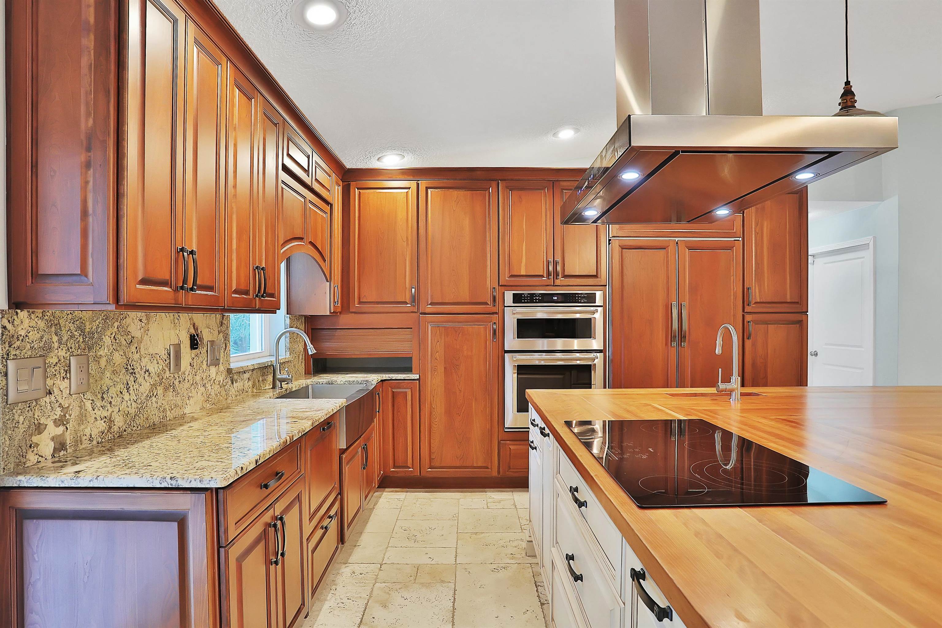 405 Boating Club Road St. Augustine, FL 32084 - Photo 13 of 35 a kitchen with stainless steel appliances granite countertop a sink and dishwasher a stove with wooden floor