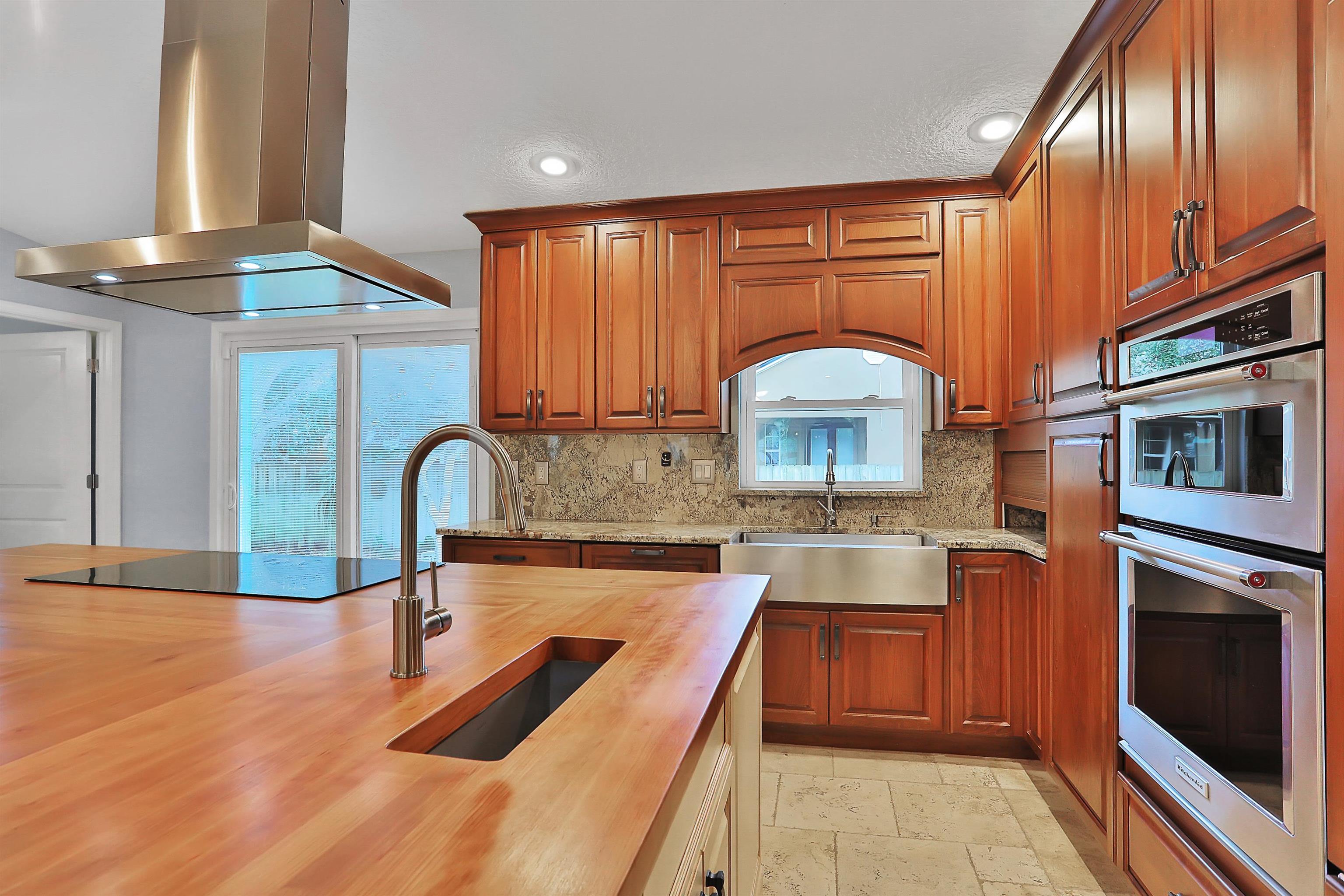 405 Boating Club Road St. Augustine, FL 32084 - Photo 15 of 35 a kitchen with stainless steel appliances granite countertop a sink stove and cabinets