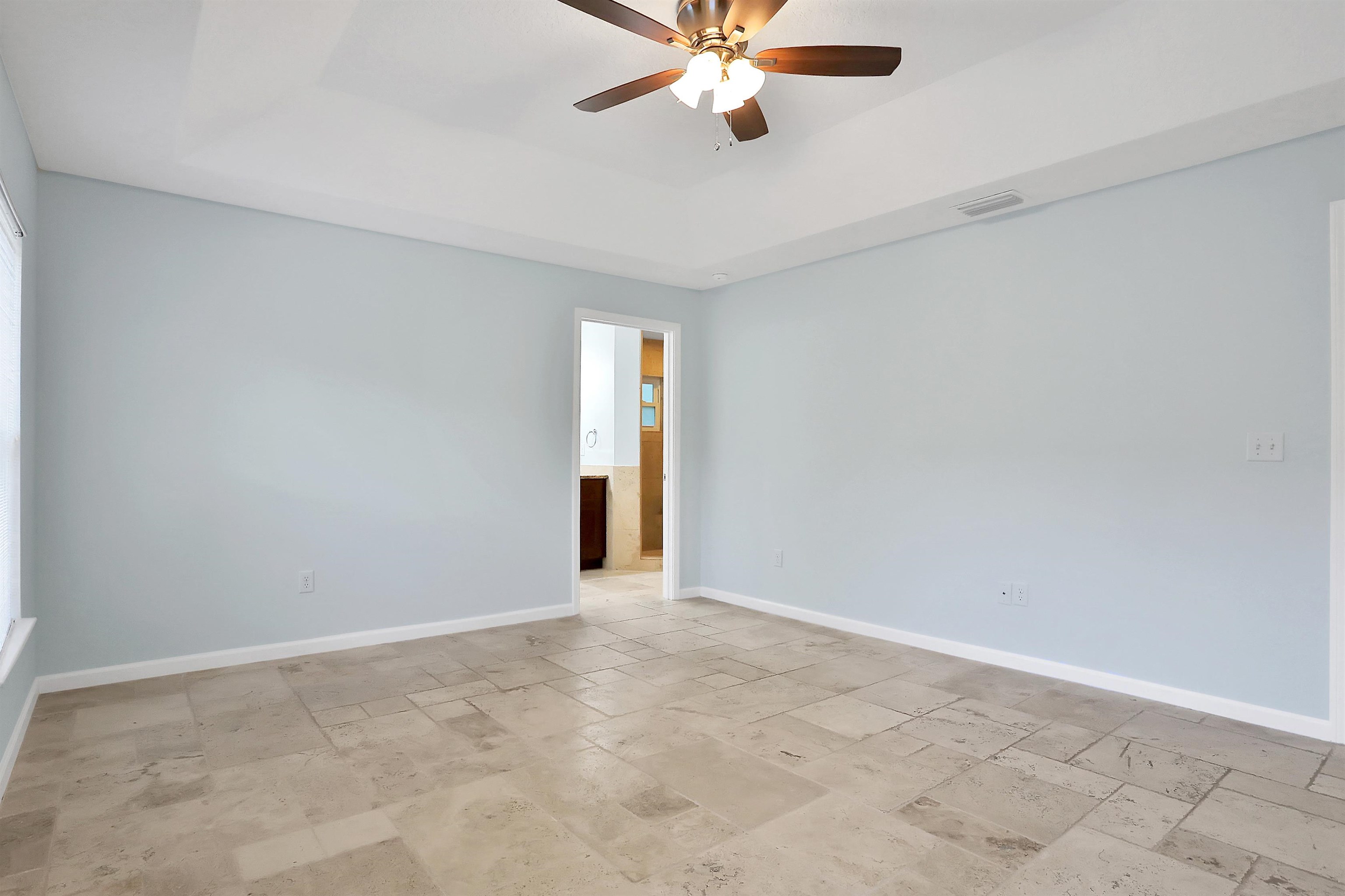 405 Boating Club Road St. Augustine, FL 32084 - Photo 22 of 35 an empty room with a chandelier fan and windows