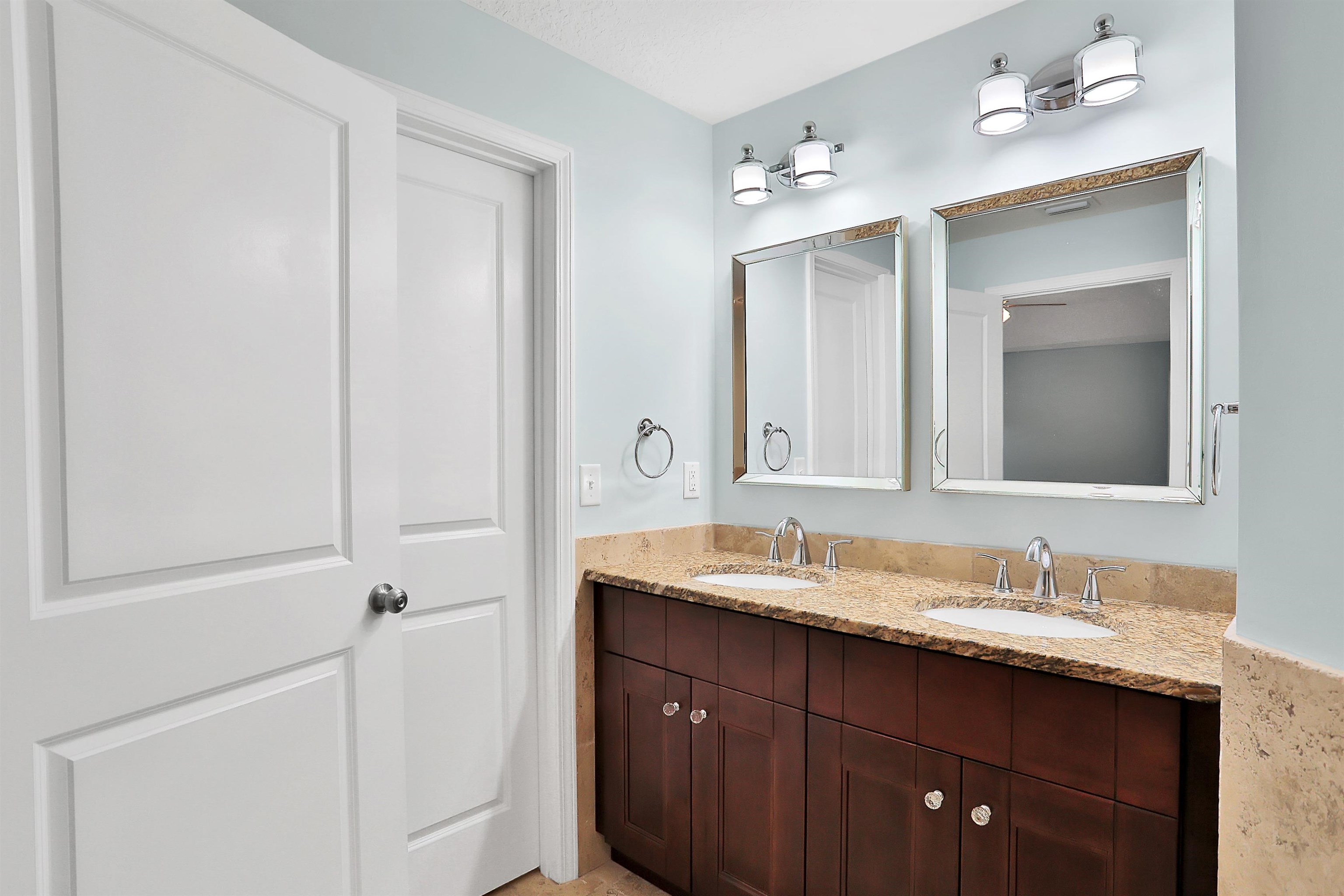 405 Boating Club Road St. Augustine, FL 32084 - Photo 26 of 35 a bathroom with a double vanity sink and a mirror