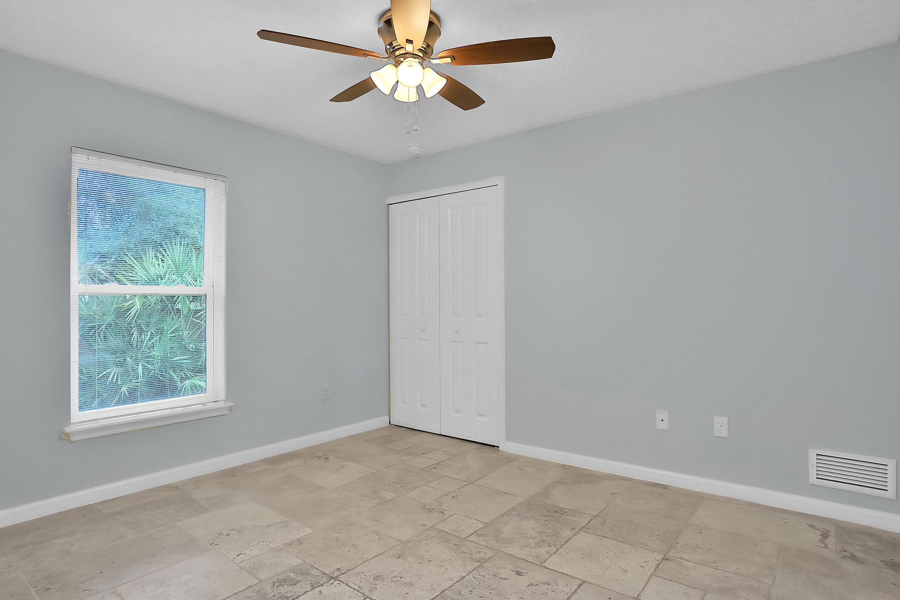 405 Boating Club Road St. Augustine, FL 32084 - Photo 32 of 35 an empty room with a window and a fan