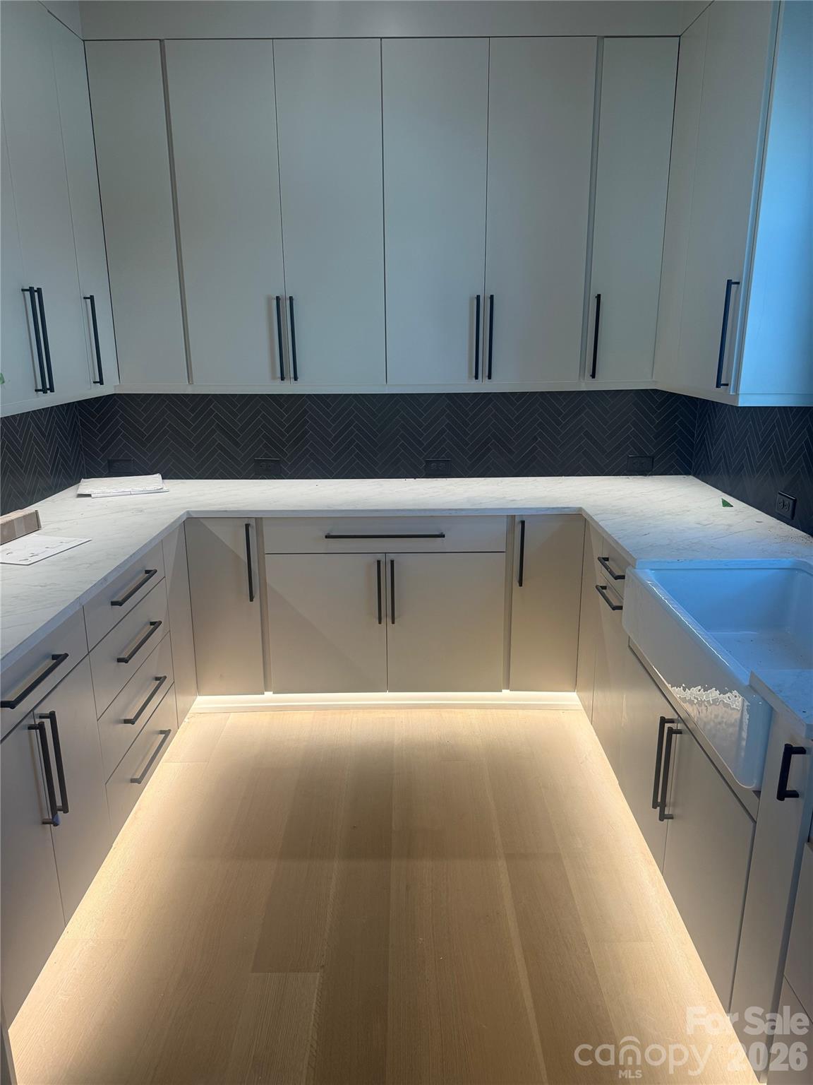 22554 John Gamble Road Cornelius, NC 28031 - Photo 15 of 45 a kitchen with a sink and cabinets