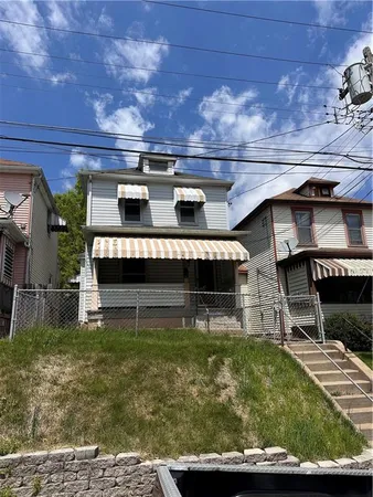 a view of a house with a yard balcony and sitting area