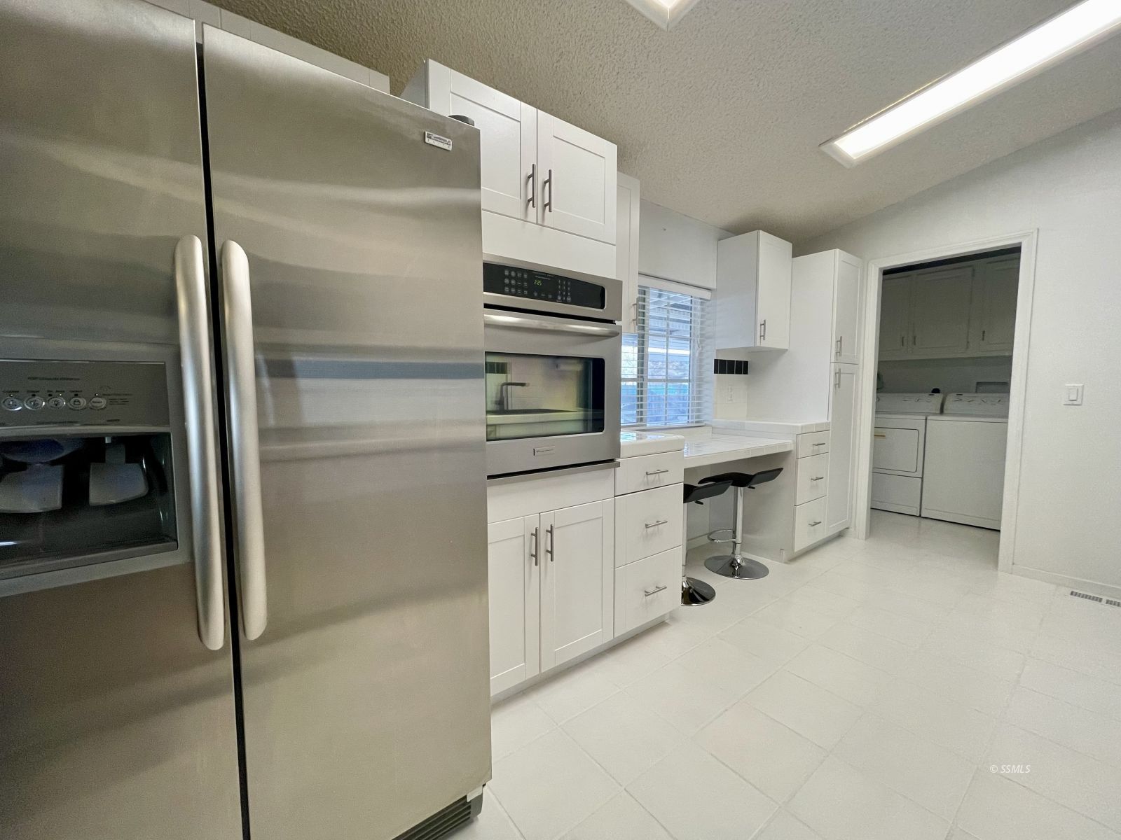 1449 Dunes Street Ridgecrest, CA 93555 - Photo 10 of 50 a kitchen with a refrigerator an oven