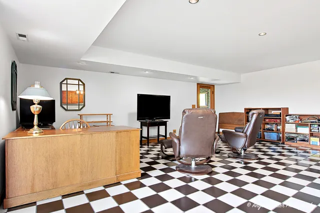 a living room with furniture a flat screen tv and kitchen view