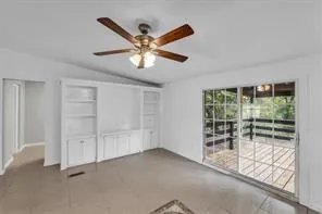 a view of a livingroom with a ceiling fan and window
