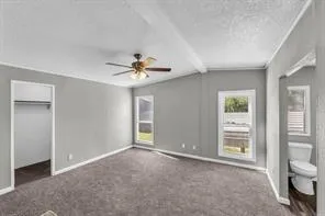 a view of a room with a ceiling fan and bathroom