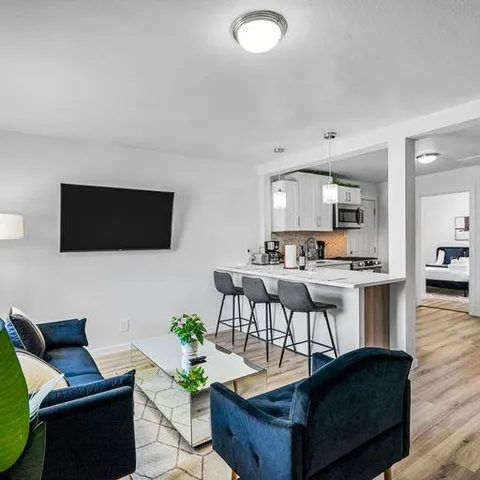 a living room with fireplace furniture and a flat screen tv