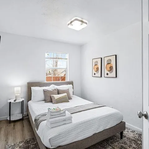 a bedroom with a bed and a window