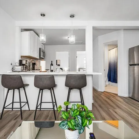 a kitchen with stainless steel appliances kitchen island a chandelier