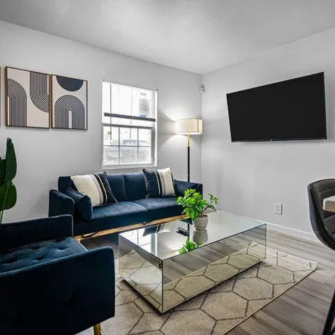 a living room with furniture and a flat screen tv