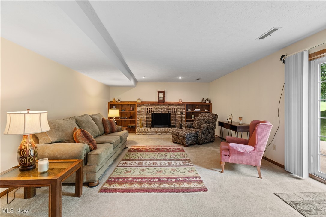 2560 Rutt Court Wooster, OH 44691 - Photo 18 of 33 Carpeted living area featuring a brick fireplace