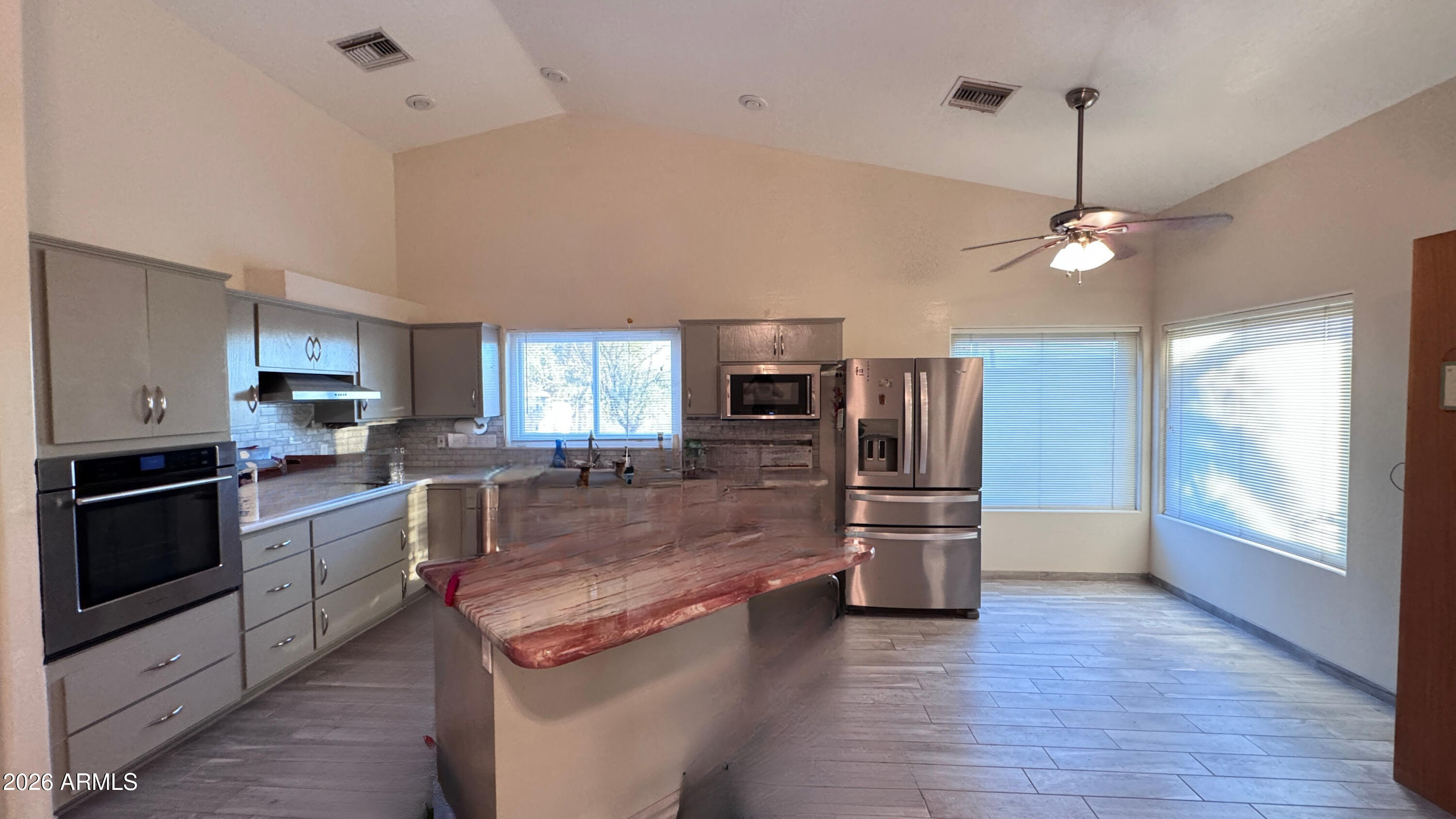 3640 North Prospectors Road Apache Junction, AZ 85119 - Photo 8 of 17 a kitchen with stainless steel appliances granite countertop a refrigerator stove and oven