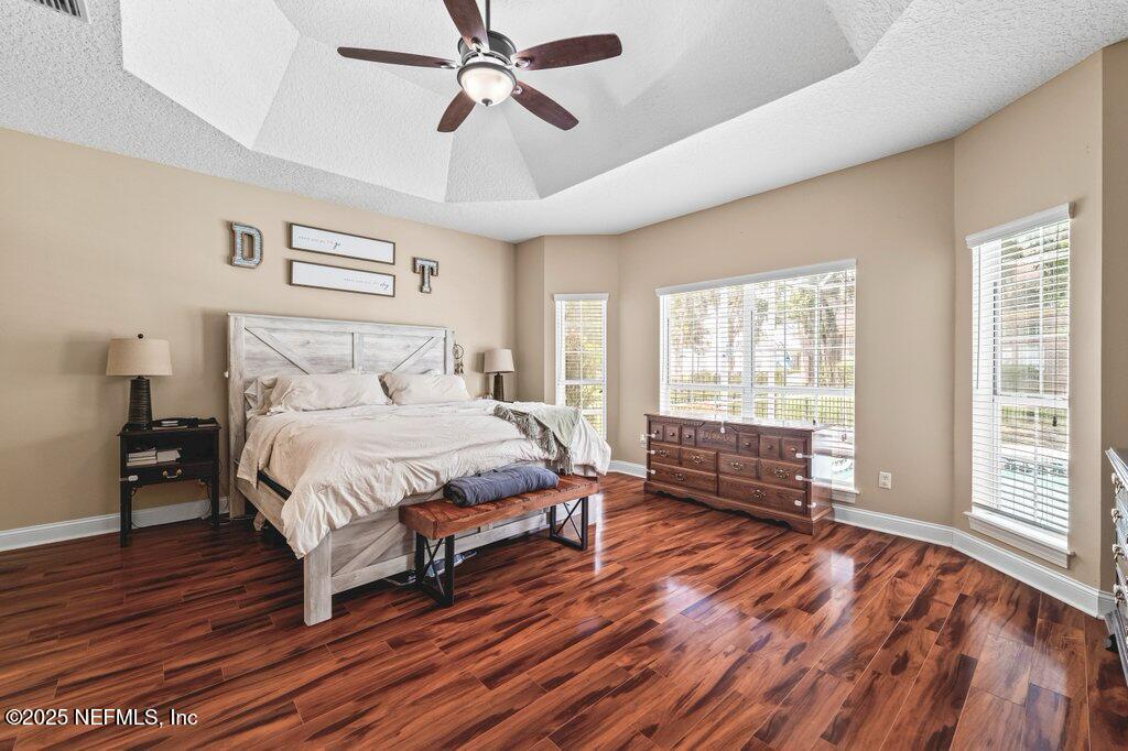 729 Cherry Grove Road Orange Park, FL 32073 - Photo 15 of 34 a bedroom with a bed and wooden floor