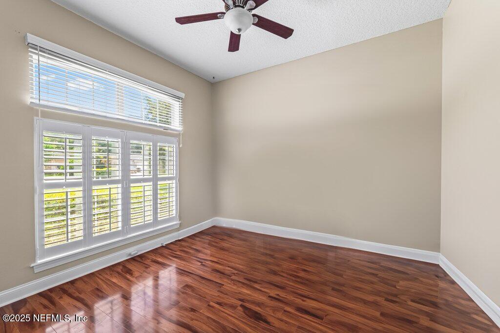 729 Cherry Grove Road Orange Park, FL 32073 - Photo 18 of 34 a view of an empty room with wooden floor and a window