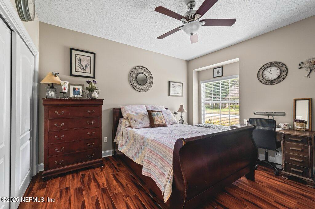 729 Cherry Grove Road Orange Park, FL 32073 - Photo 19 of 34 a bedroom with a bed and a chandelier
