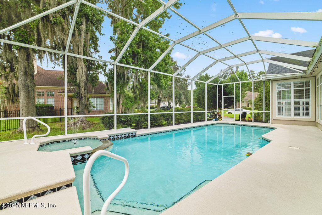 729 Cherry Grove Road Orange Park, FL 32073 - Photo 2 of 34 a view of a swimming pool with a porch and furniture