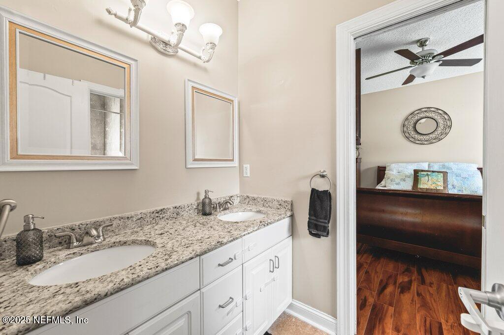 729 Cherry Grove Road Orange Park, FL 32073 - Photo 21 of 34 a bathroom with a granite countertop sink and a mirror